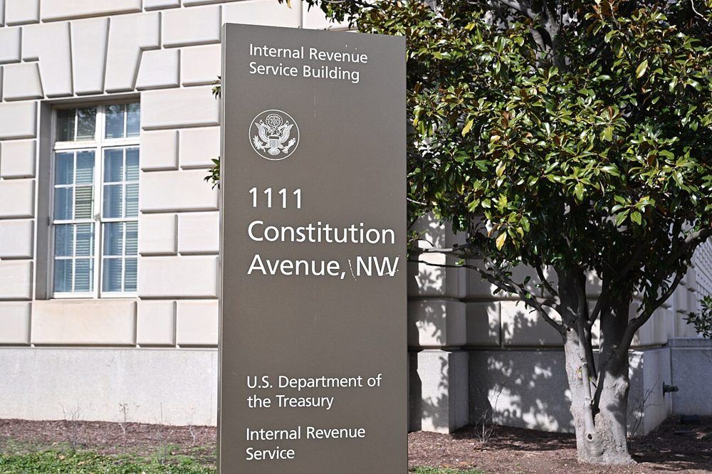 A stone sign reading Internal Revenue Service Building, 1111 Constitution Avenue NW