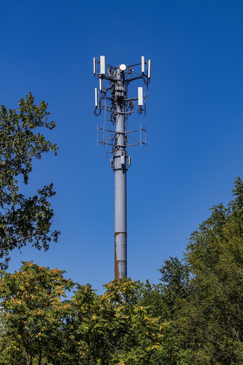 A tall metal cell phone tower with antennas near the top